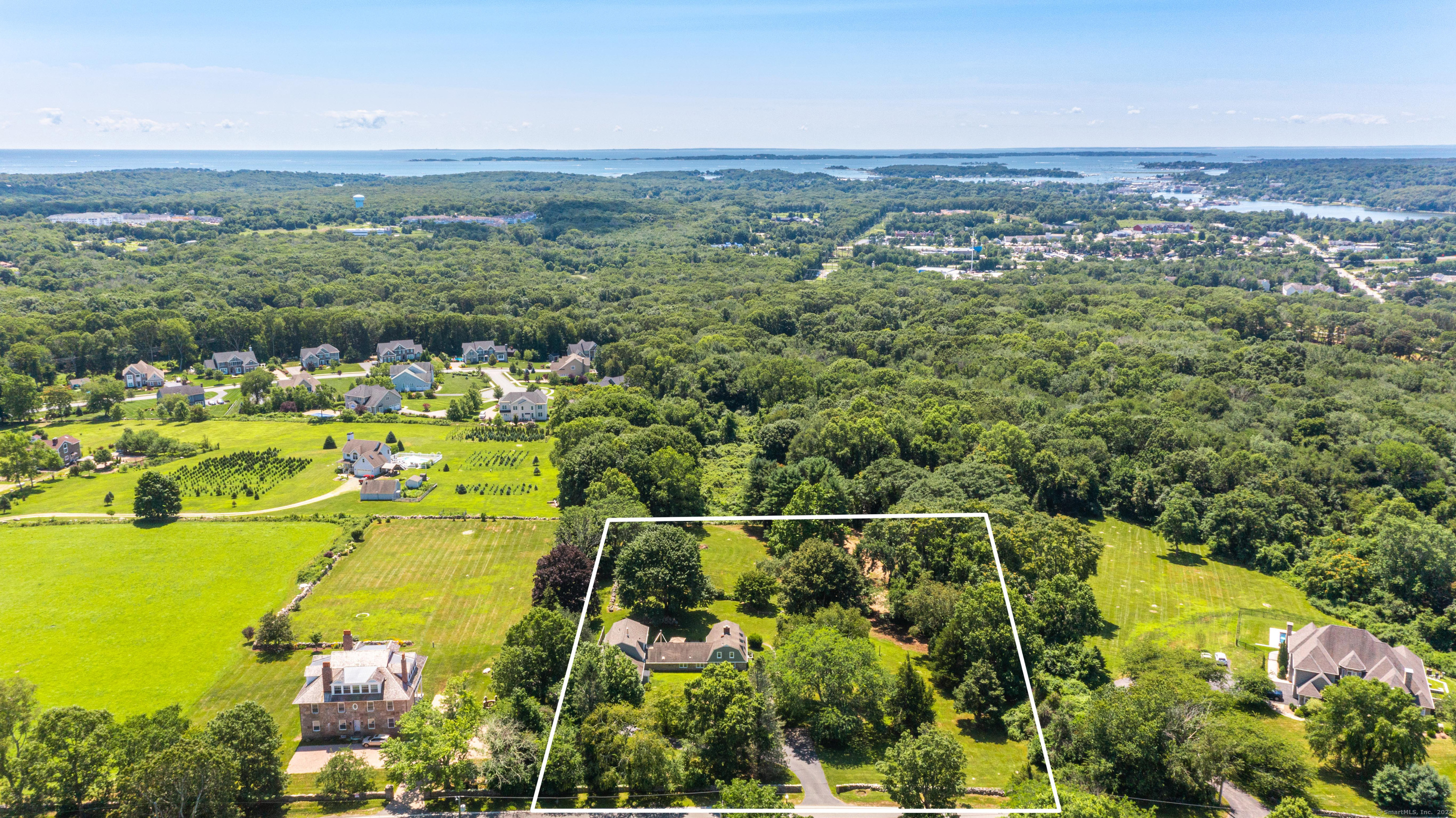 an aerial view of lake and residential houses with outdoor space