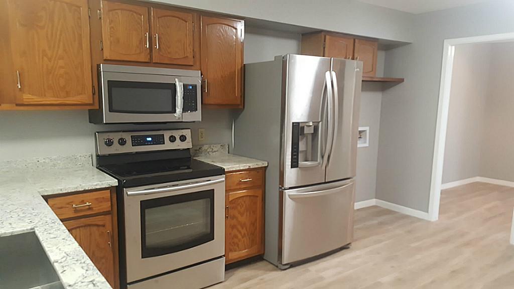 a kitchen with a stove microwave and refrigerator