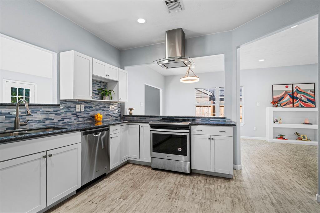 a kitchen with stainless steel appliances granite countertop a sink and stove