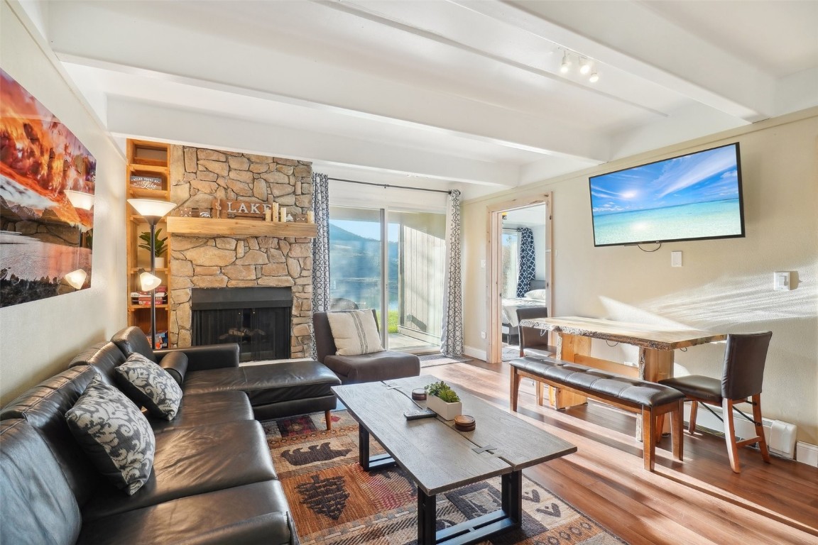 a living room with furniture a fireplace and a large window