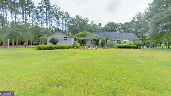 a front view of house with yard and green space