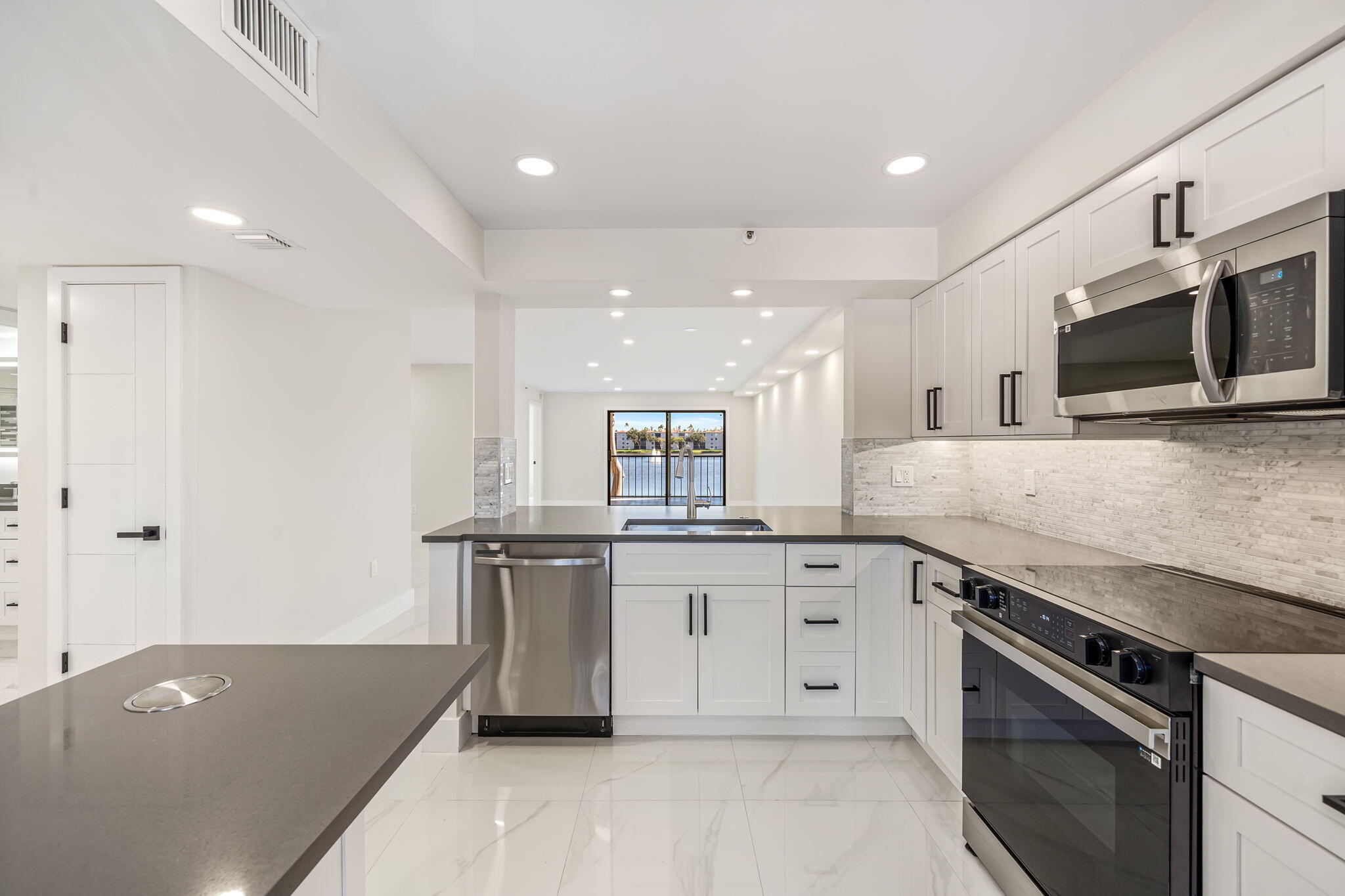 a kitchen with a sink stove and microwave