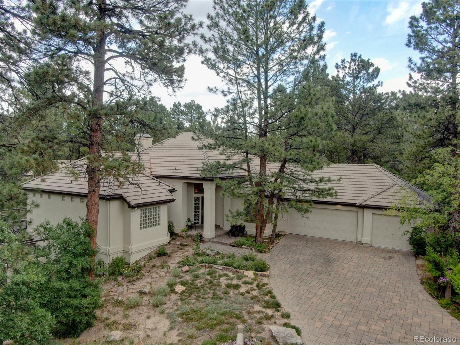 a view of a house with a yard and sitting area