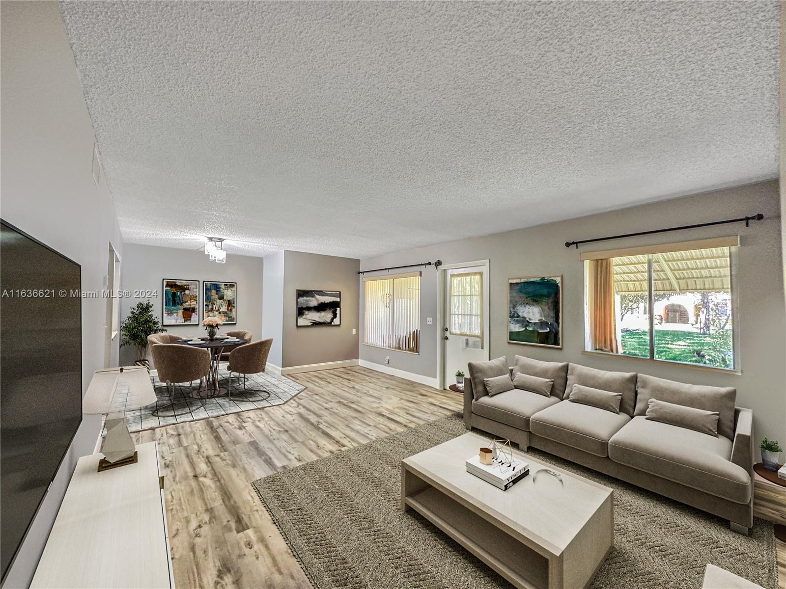 a living room with furniture window and a flat screen tv