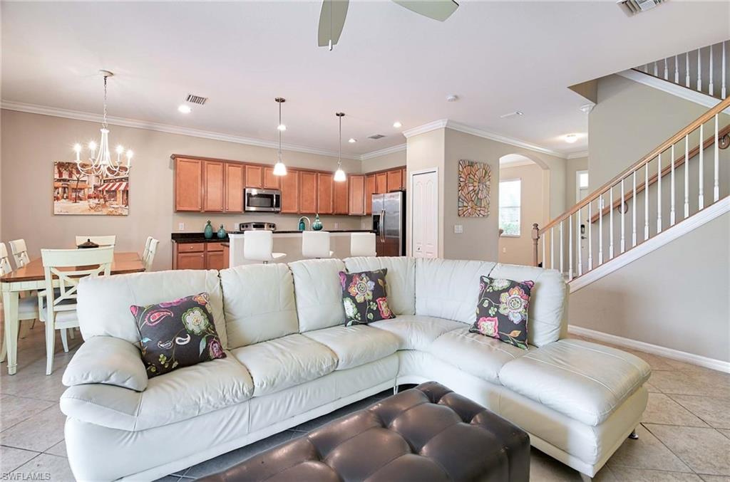 a living room with furniture and kitchen view