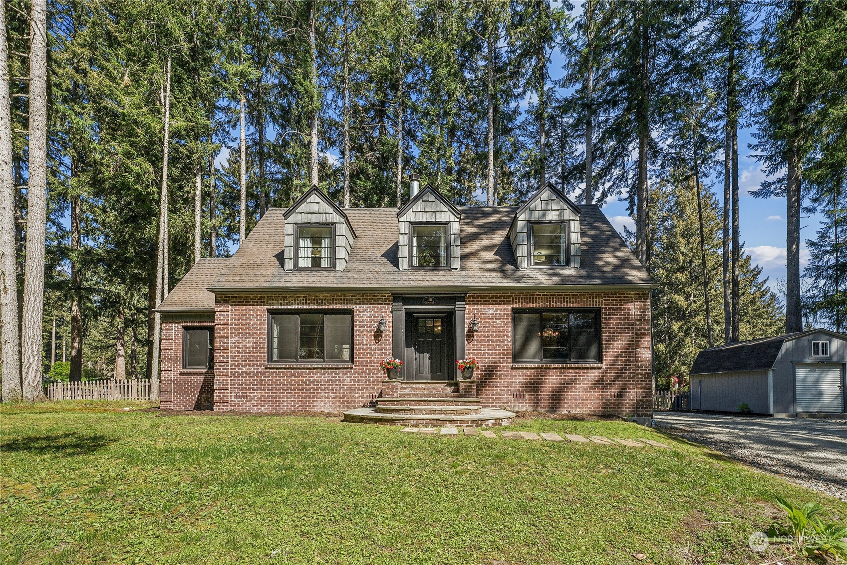 a front view of a house with a garden