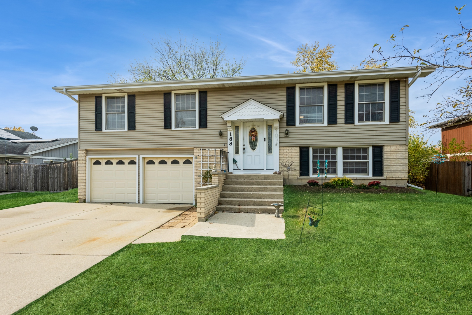 a front view of a house with a garden and yard