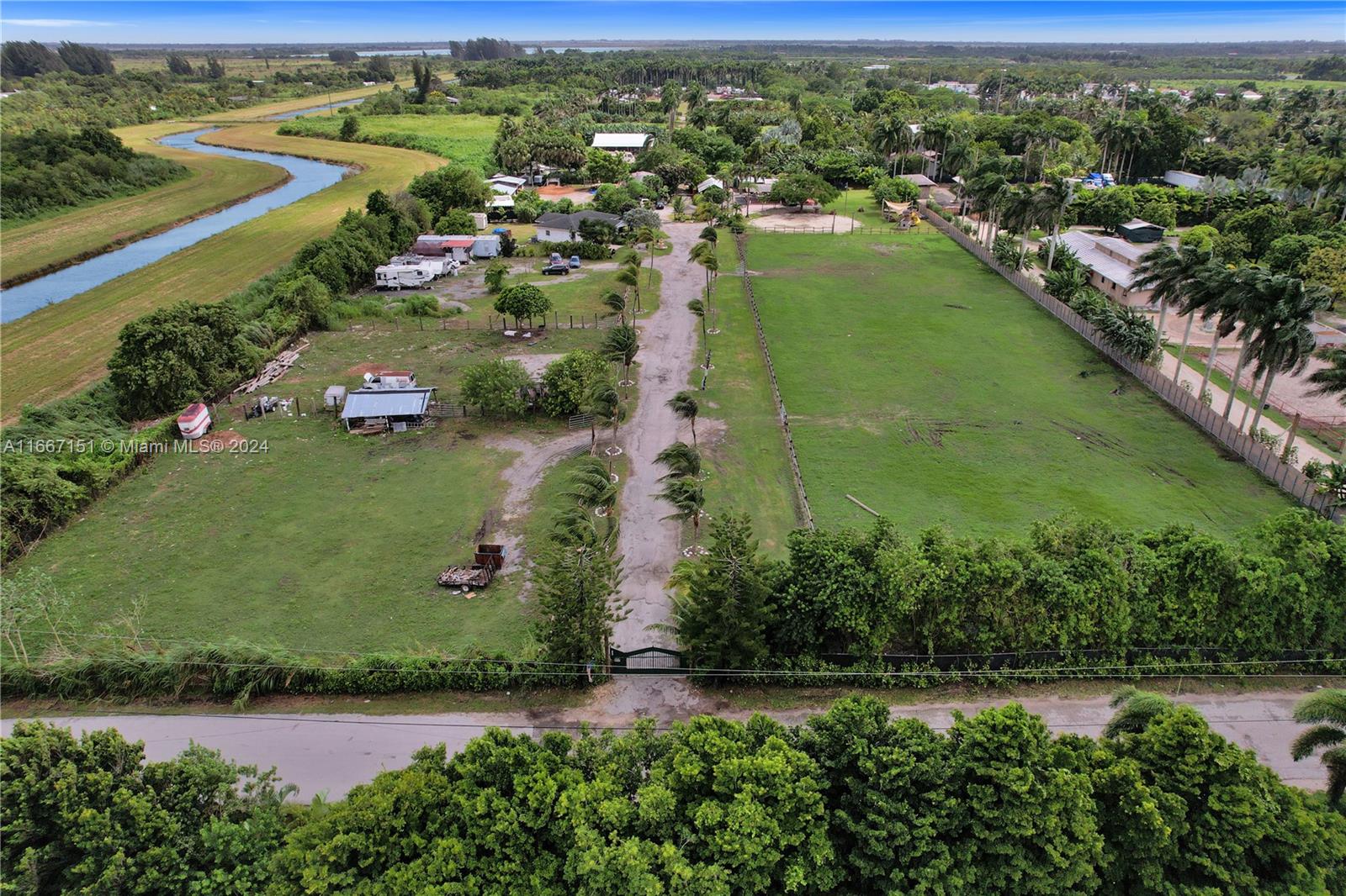 an aerial view of residential houses with outdoor space and river