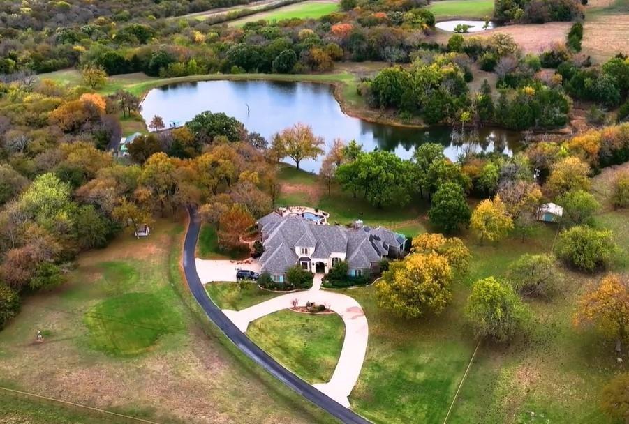 an aerial view of house with yard swimming pool and outdoor seating