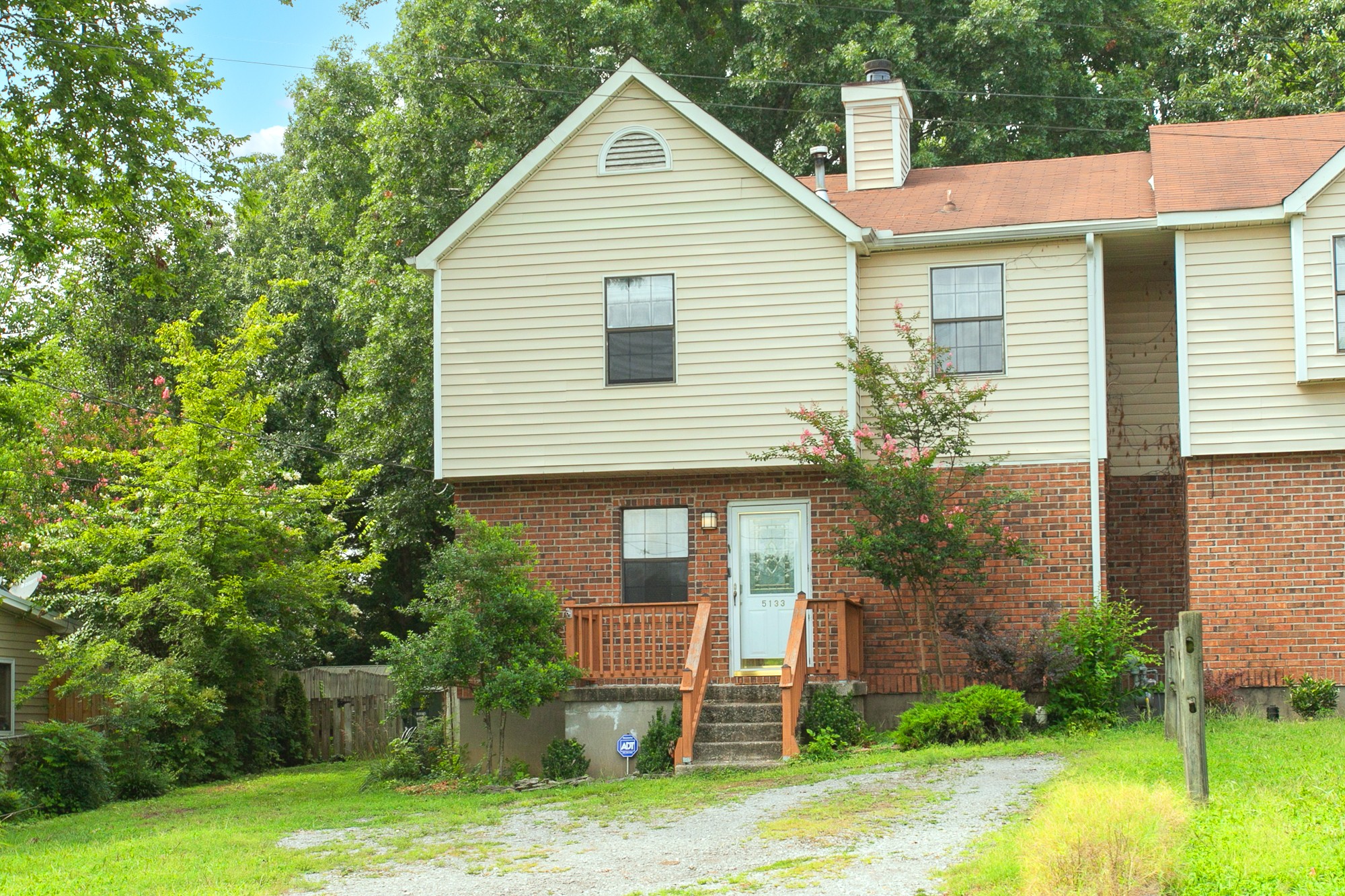 a view of a house with a yard and plants