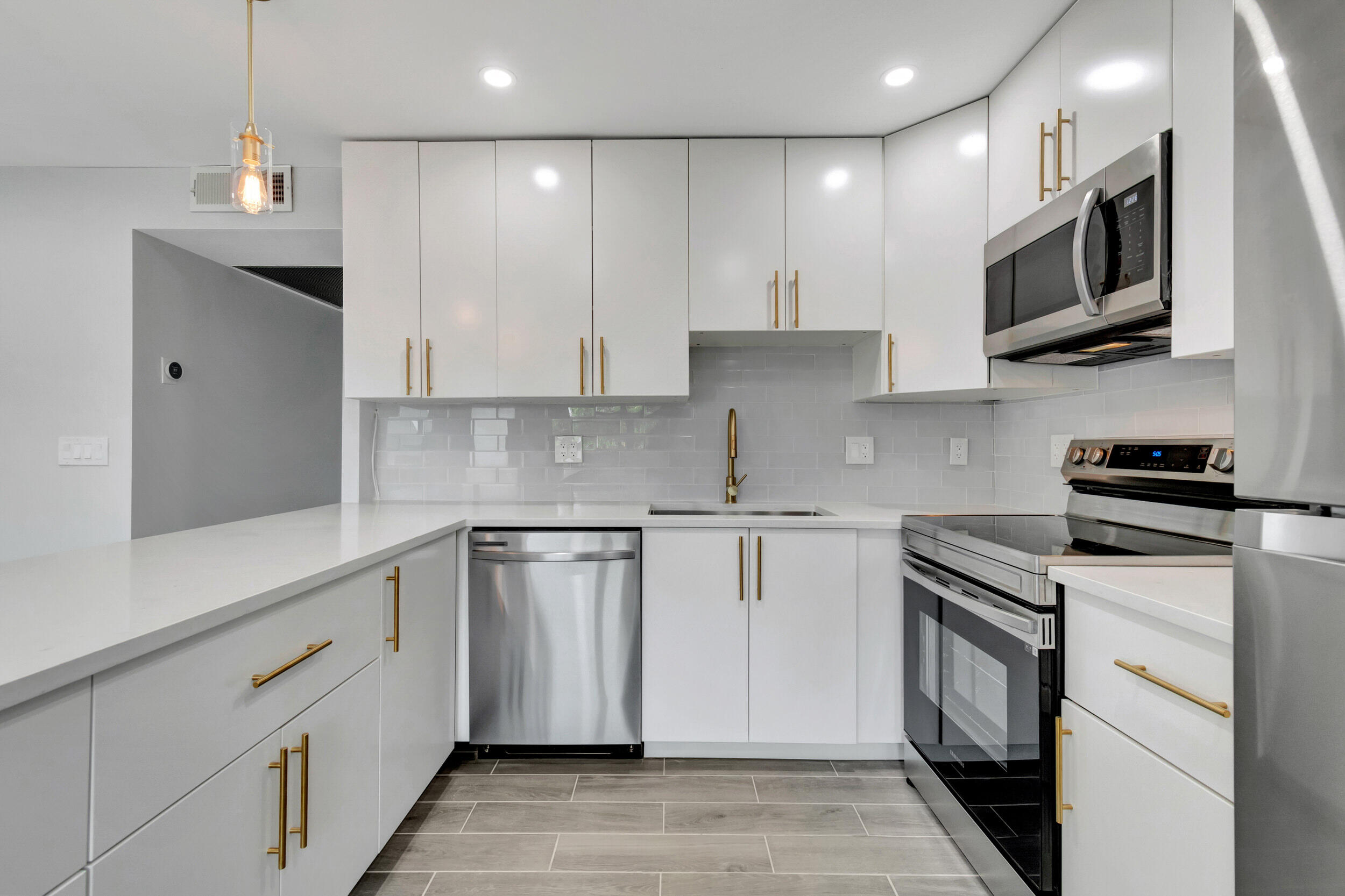 a kitchen with stainless steel appliances granite countertop a sink and a stove top oven