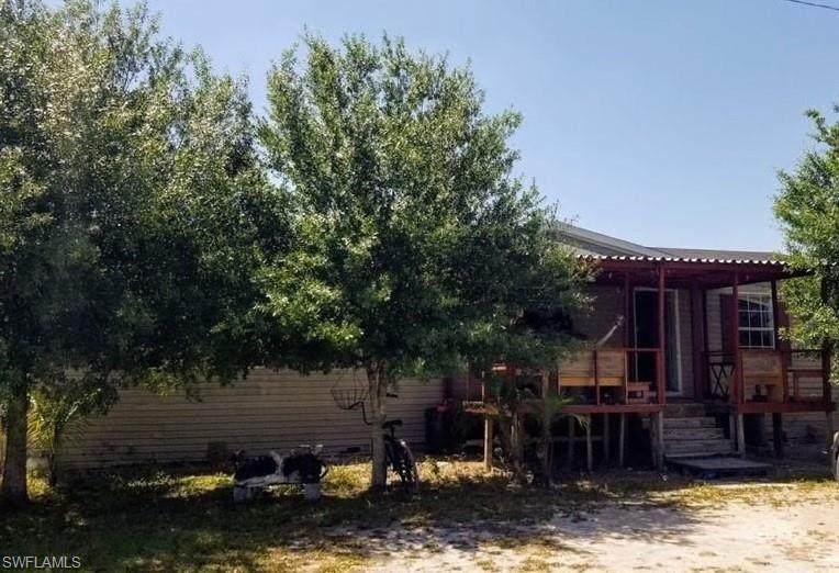 Rear view of property featuring a wooden deck