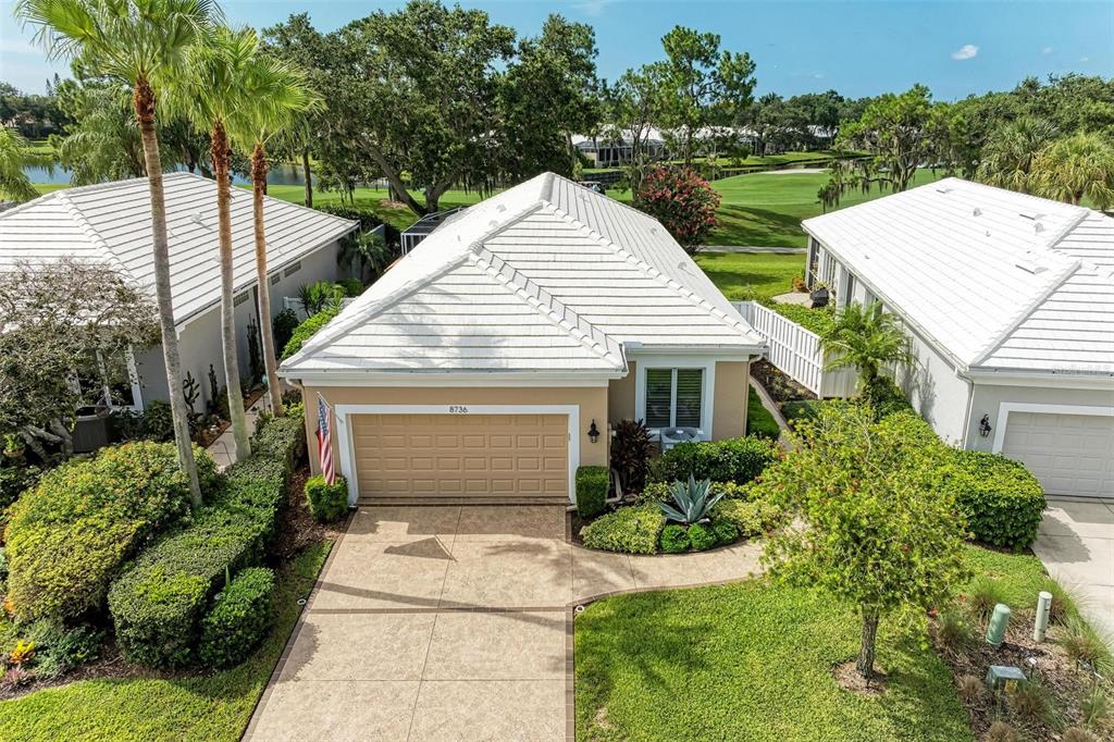 a aerial view of a house with yard and green space