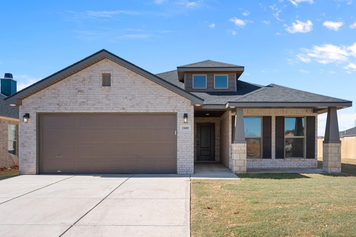 a front view of a house with garage