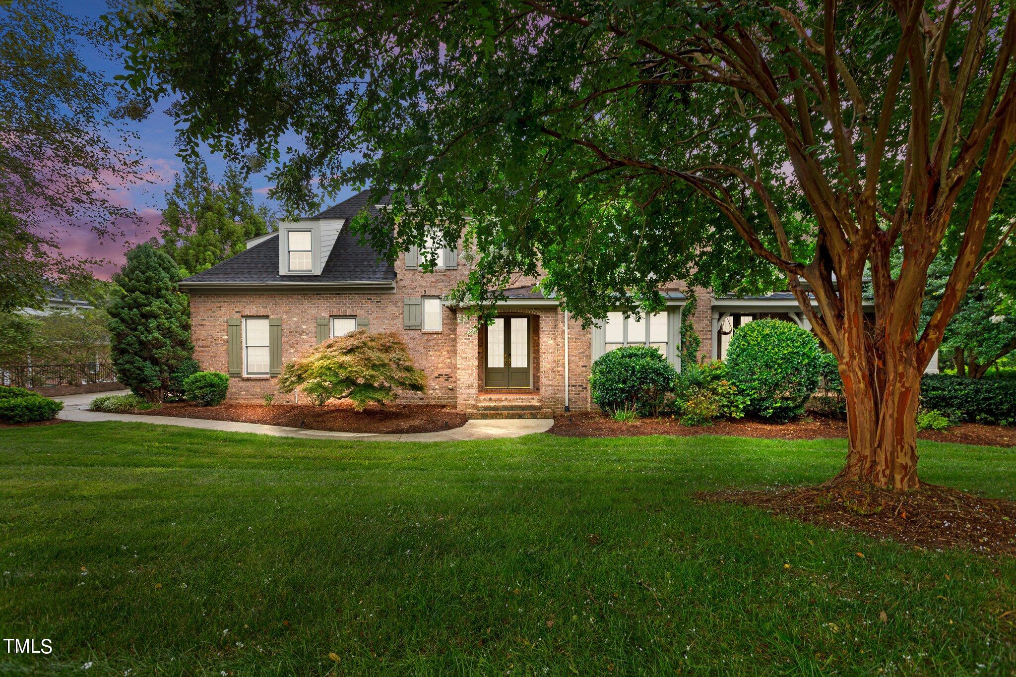 a front view of a house with a yard garden