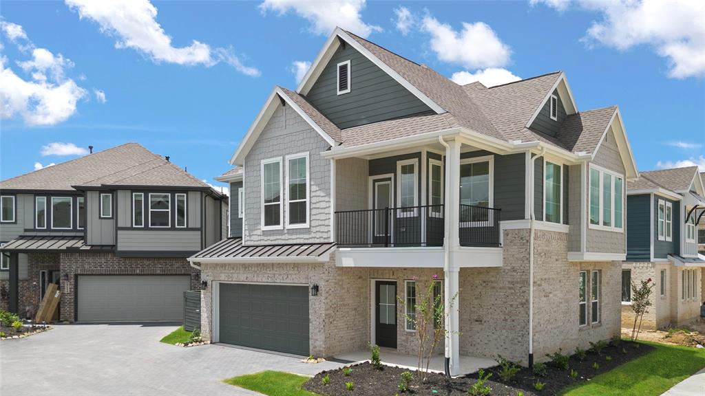 a front view of a house with a garden and garage