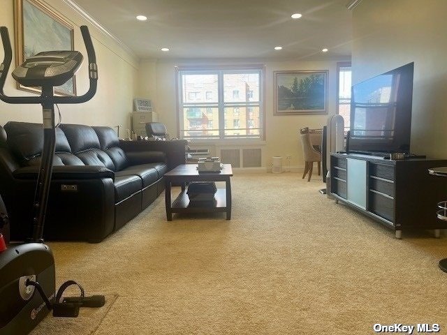 a living room with furniture a flat screen tv and a window