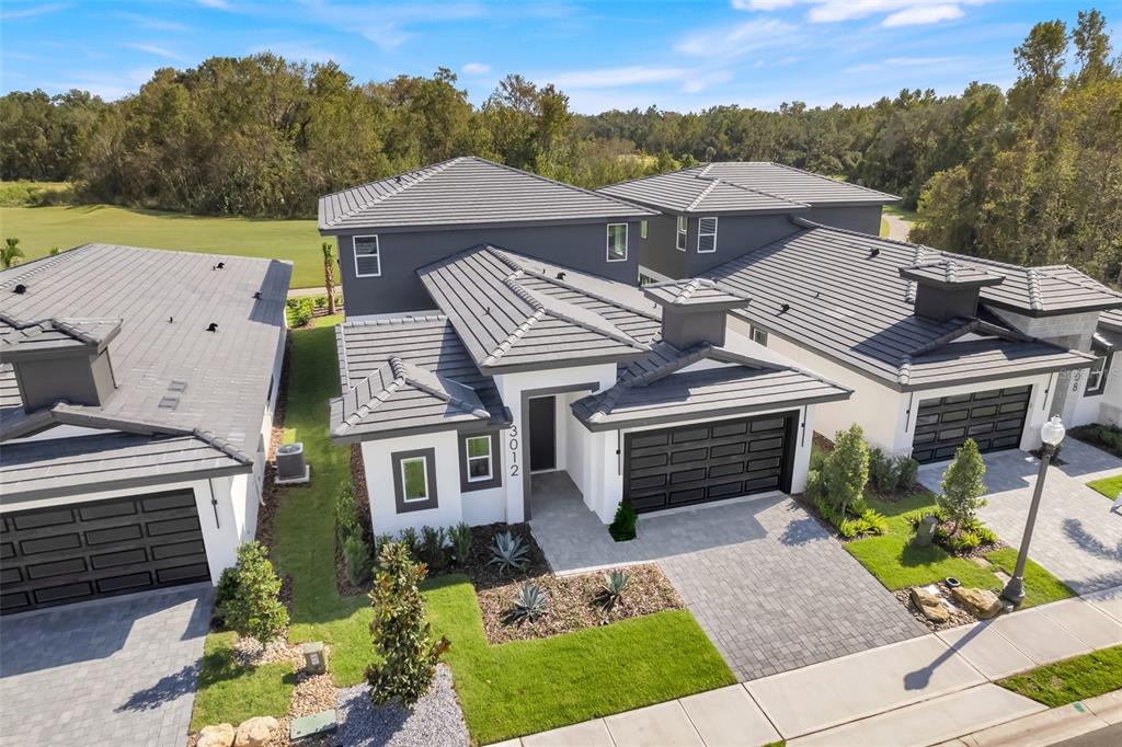 an aerial view of a house with a yard