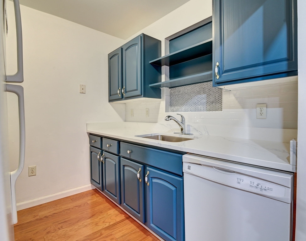 a kitchen with stainless steel appliances granite countertop a sink and a microwave