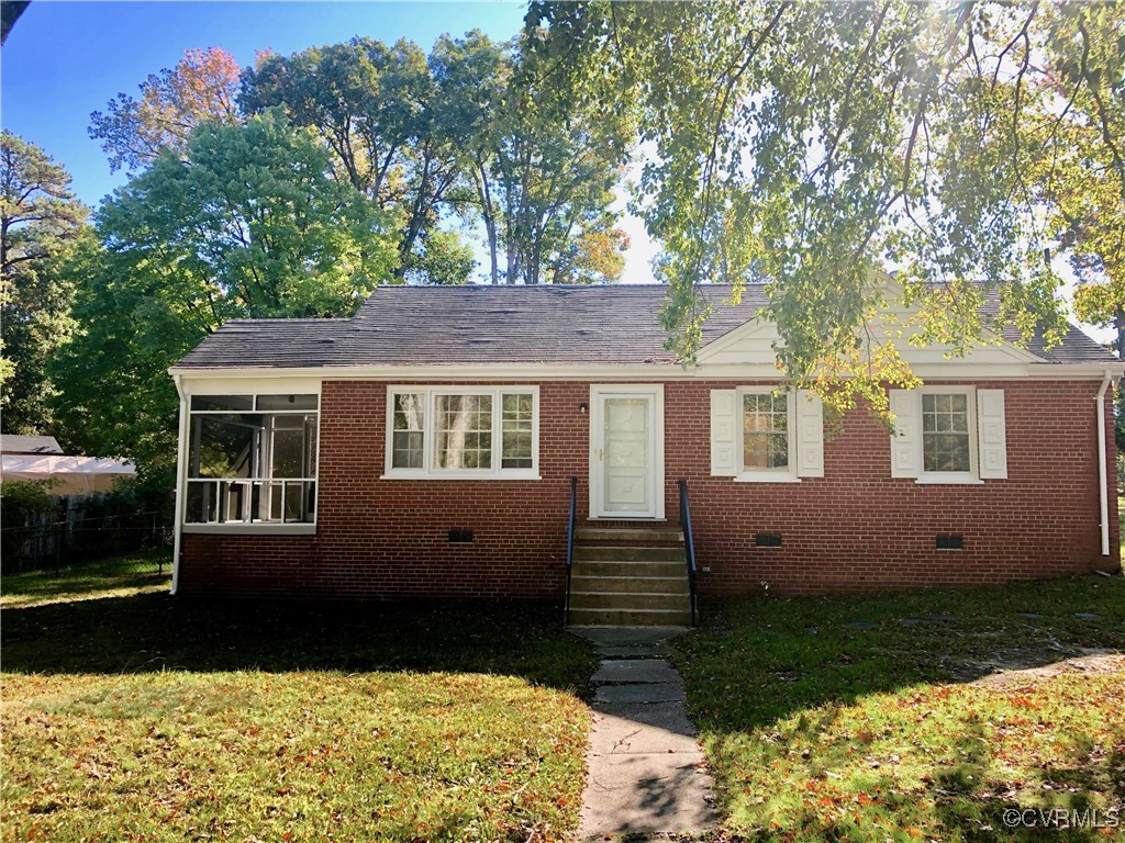 Bungalow-style home with a front lawn and a sunroo