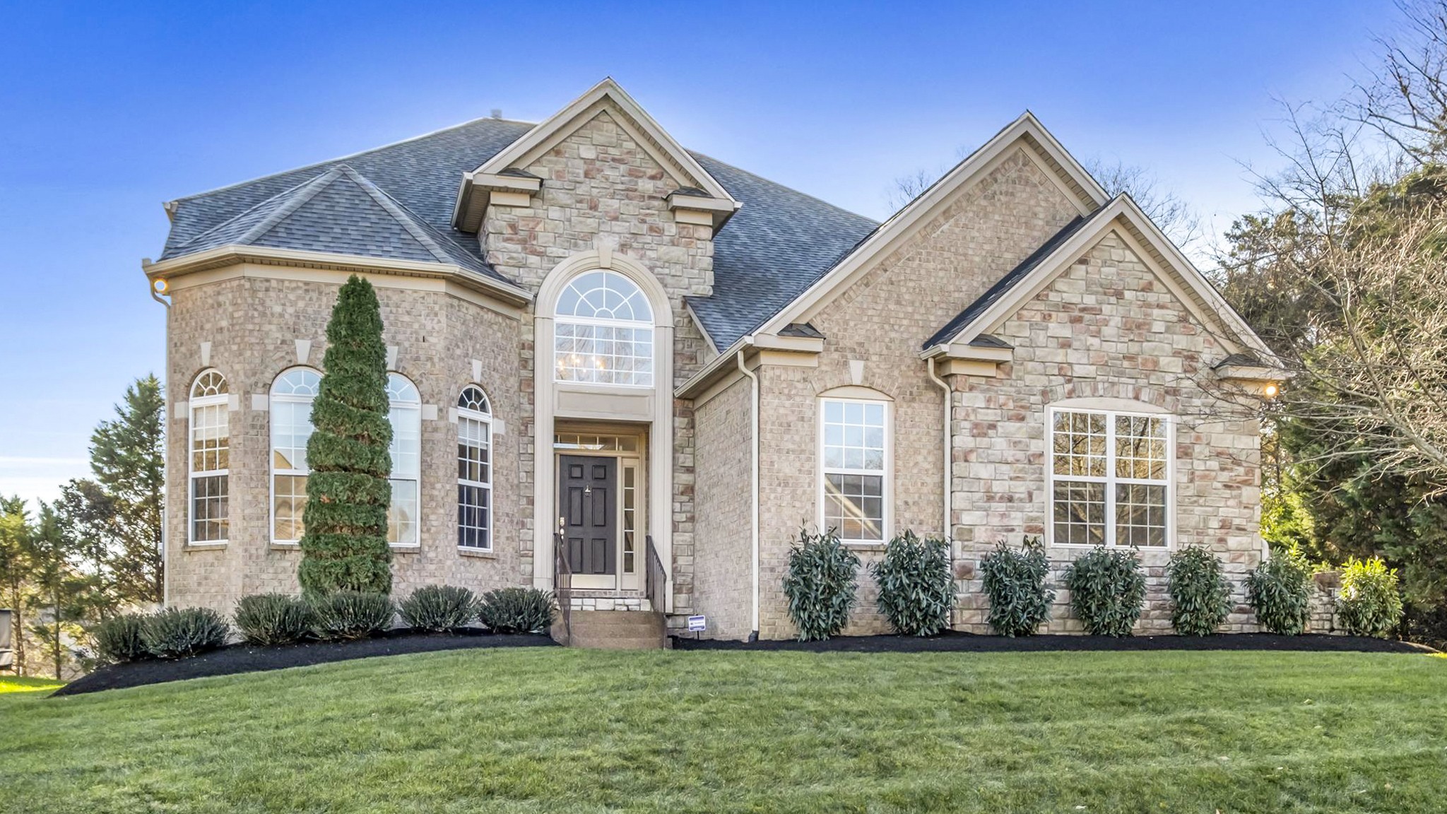 a front view of a house with a yard