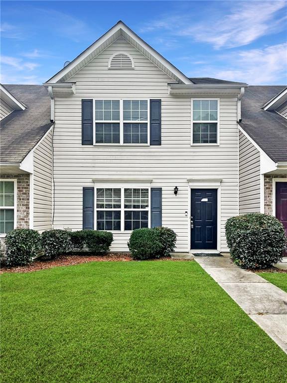 a front view of a house with a yard