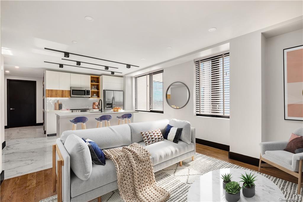 Living room with sink and light hardwood / wood-style flooring