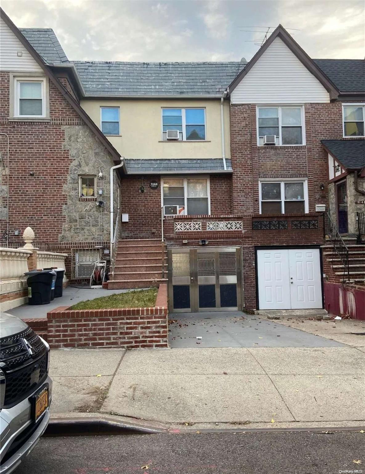 a front view of a house with parking space