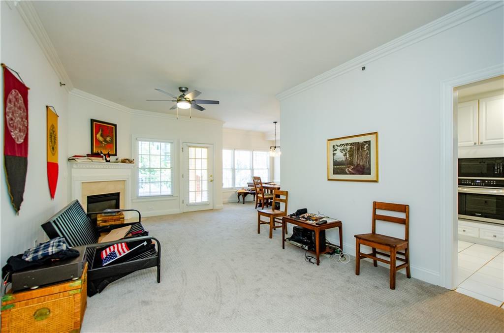 a living room with furniture fireplace and a window