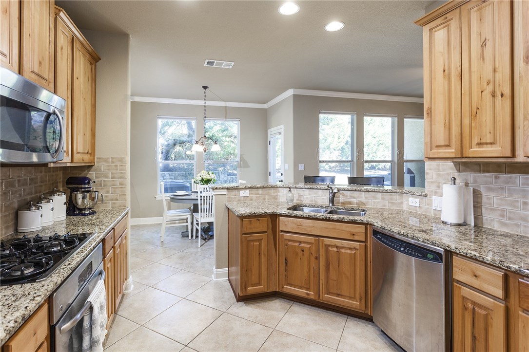 a kitchen with lots of counter top space and dining table