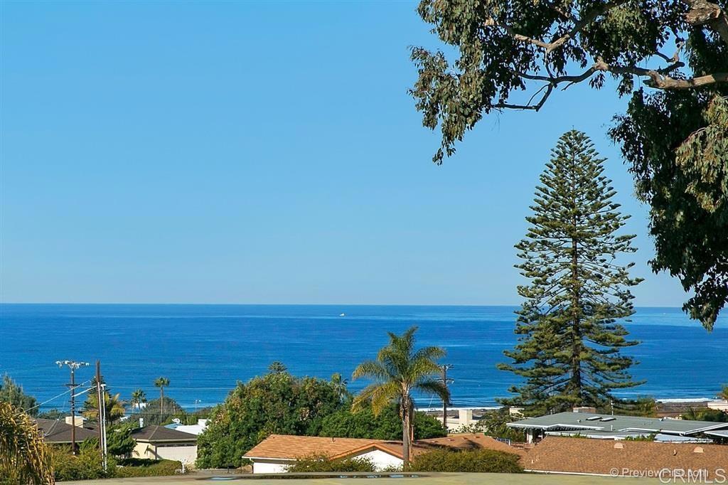 a view of ocean with a building in the background