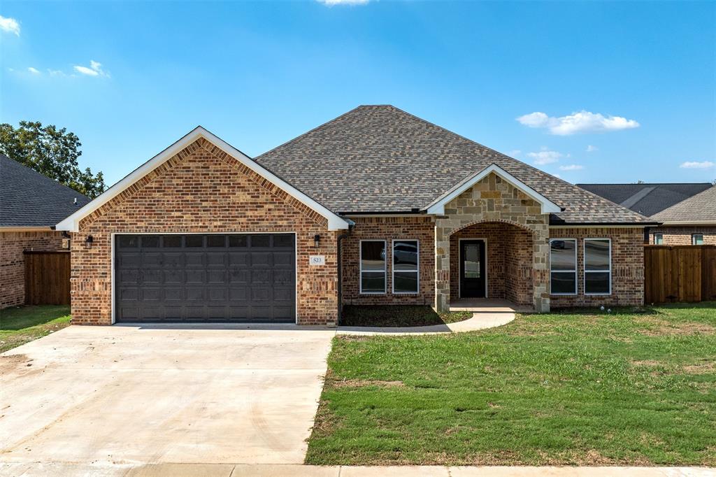 a front view of a house with a yard