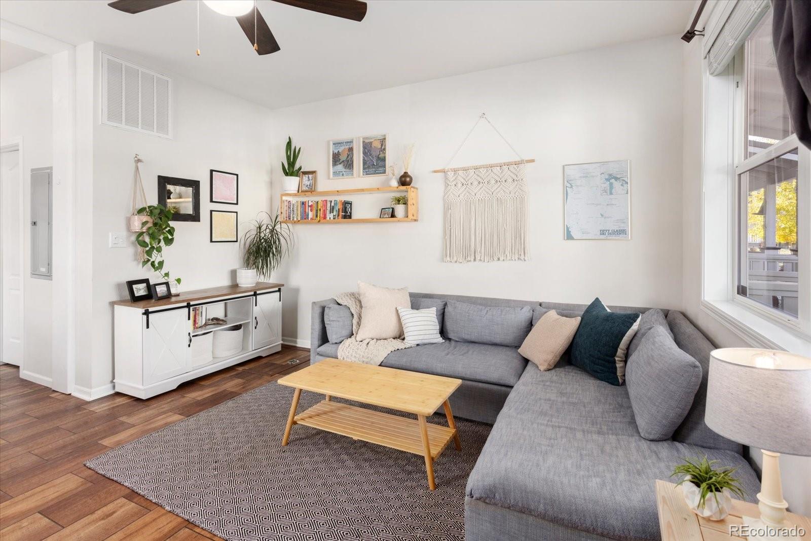 a living room with furniture and painting on the wall