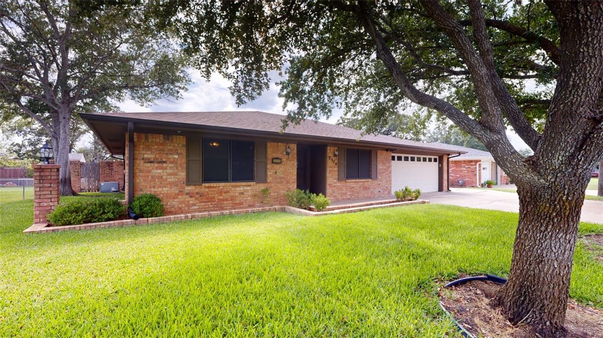 a view of a house with a yard and tree s