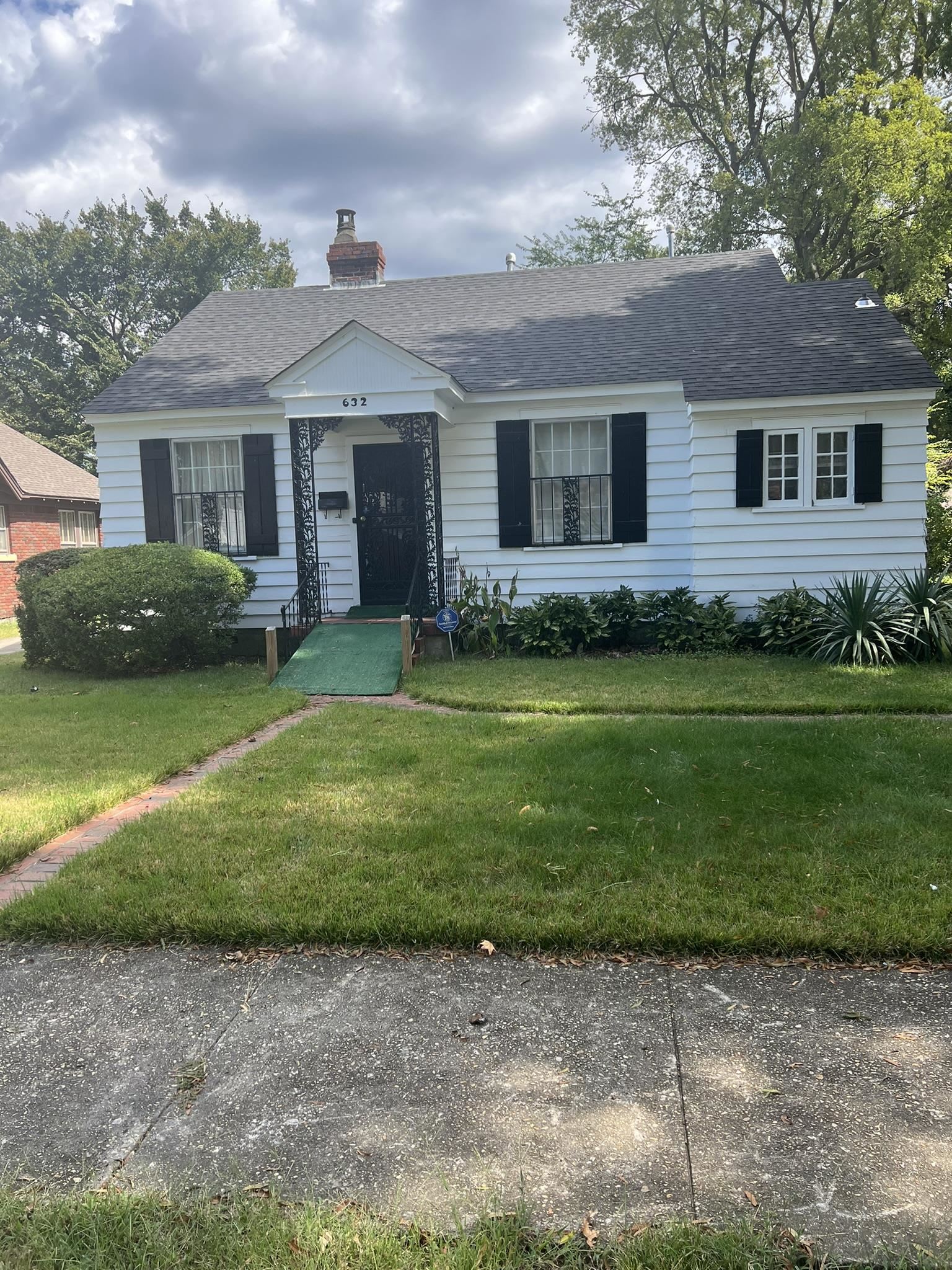 a front view of a house with garden