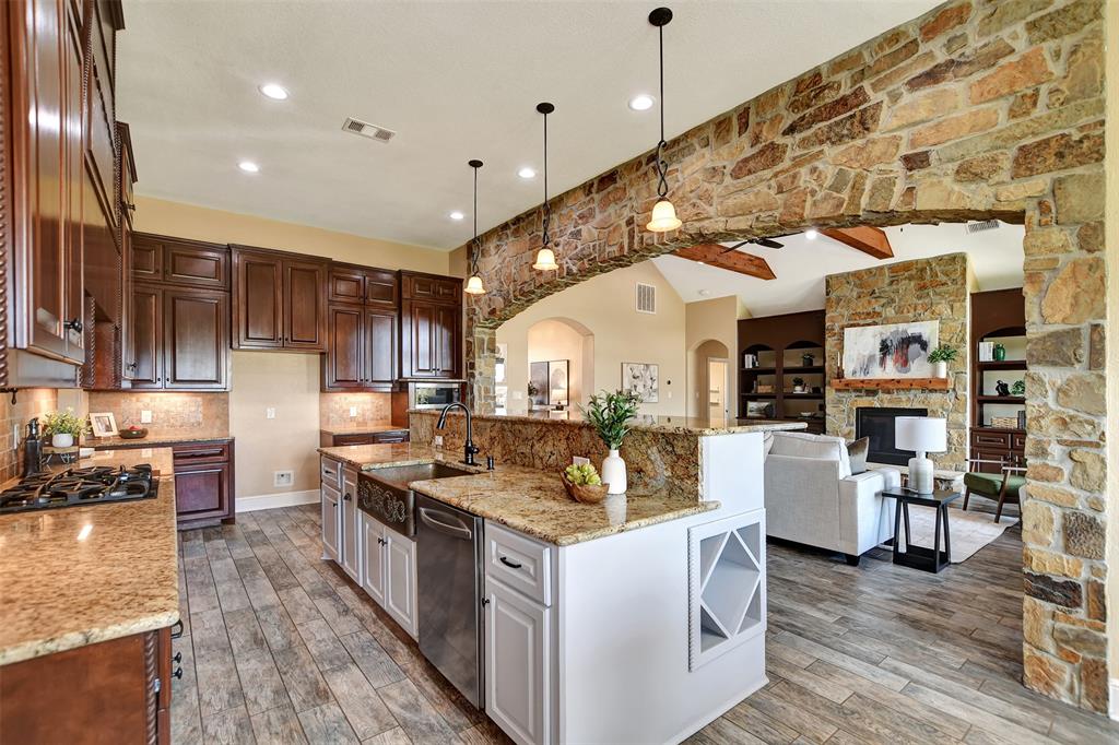 a kitchen with stainless steel appliances granite countertop a stove and cabinets