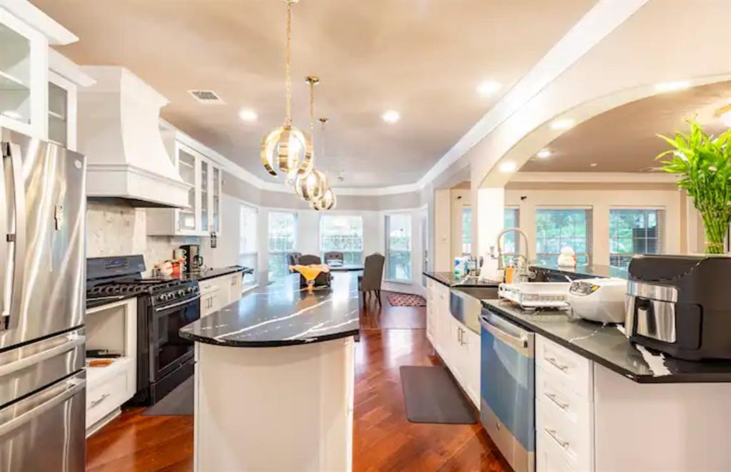 a large kitchen with lots of counter space windows and appliances