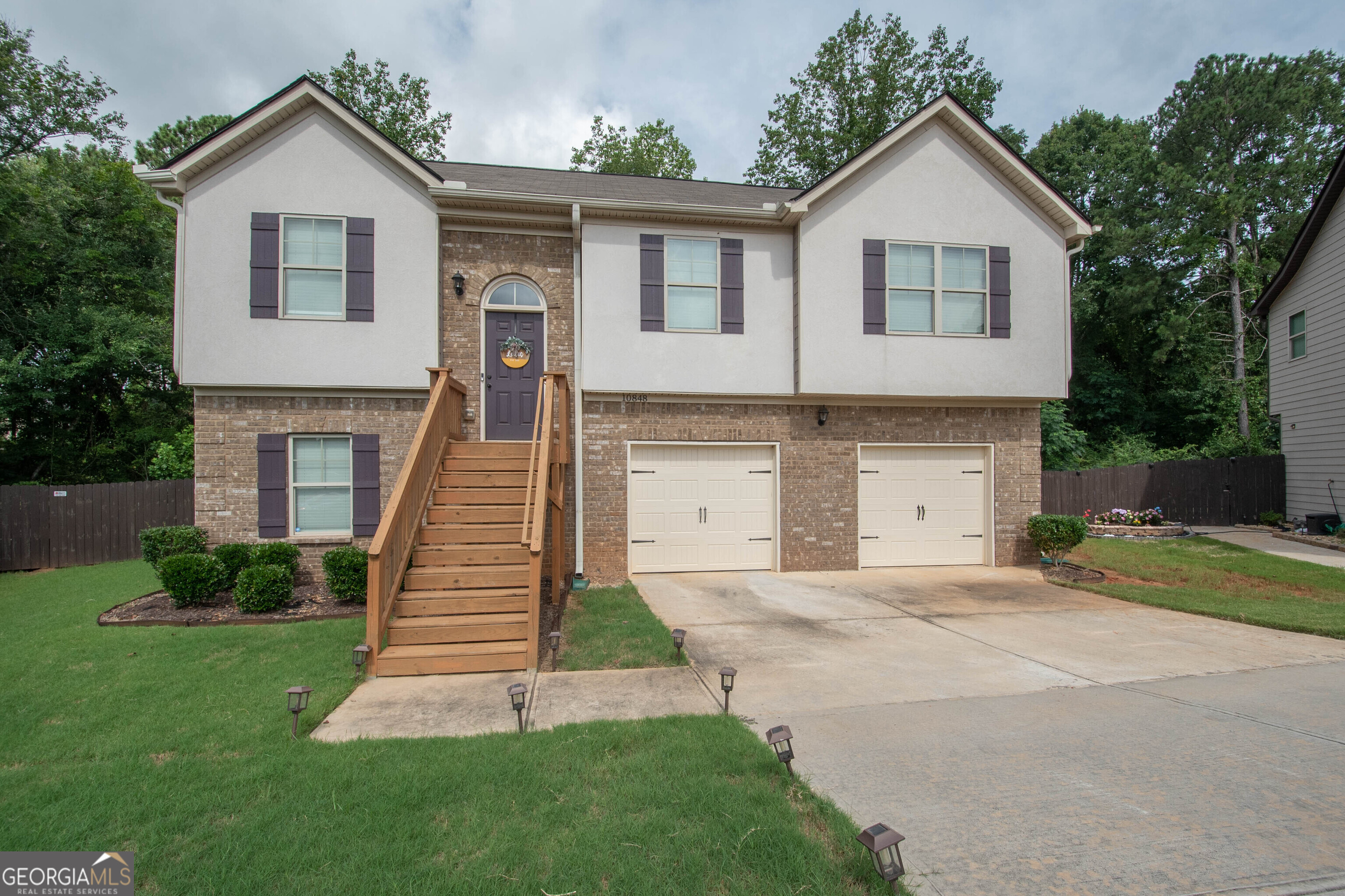 a front view of a house with a yard and garage