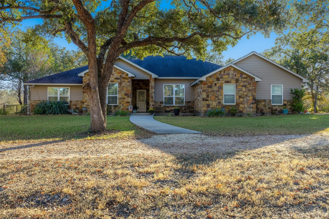 a front view of house with yard and green space