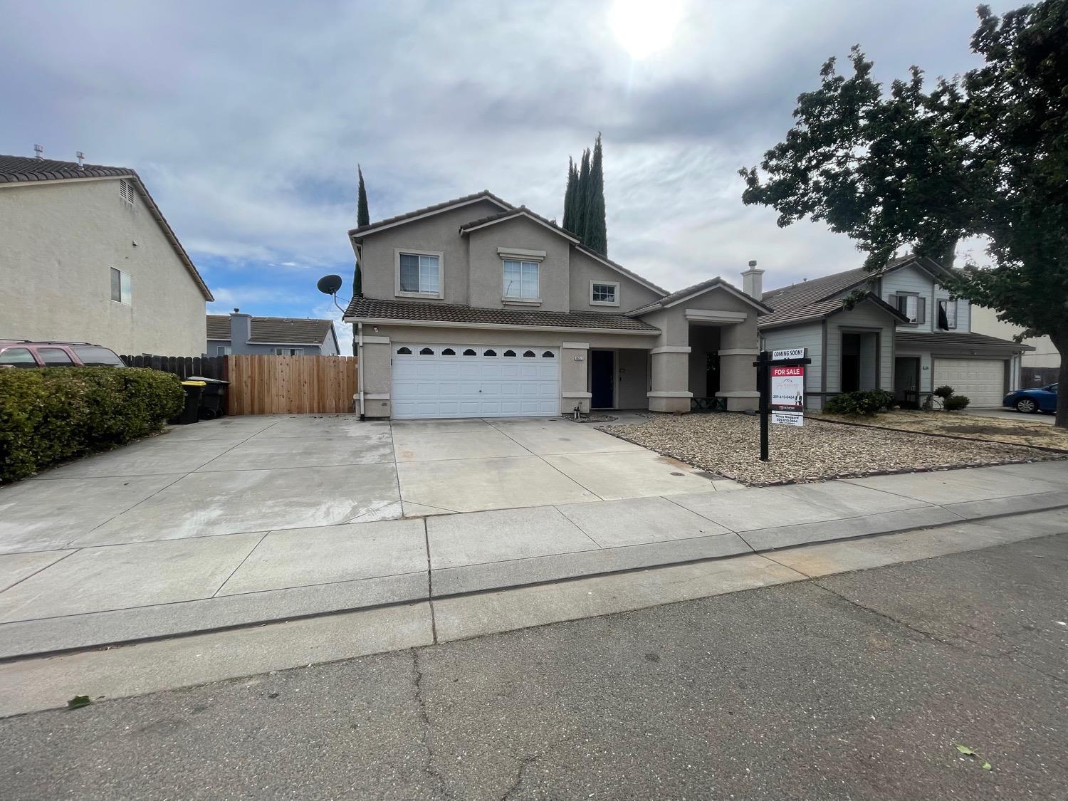 a house that has a tree in front of it