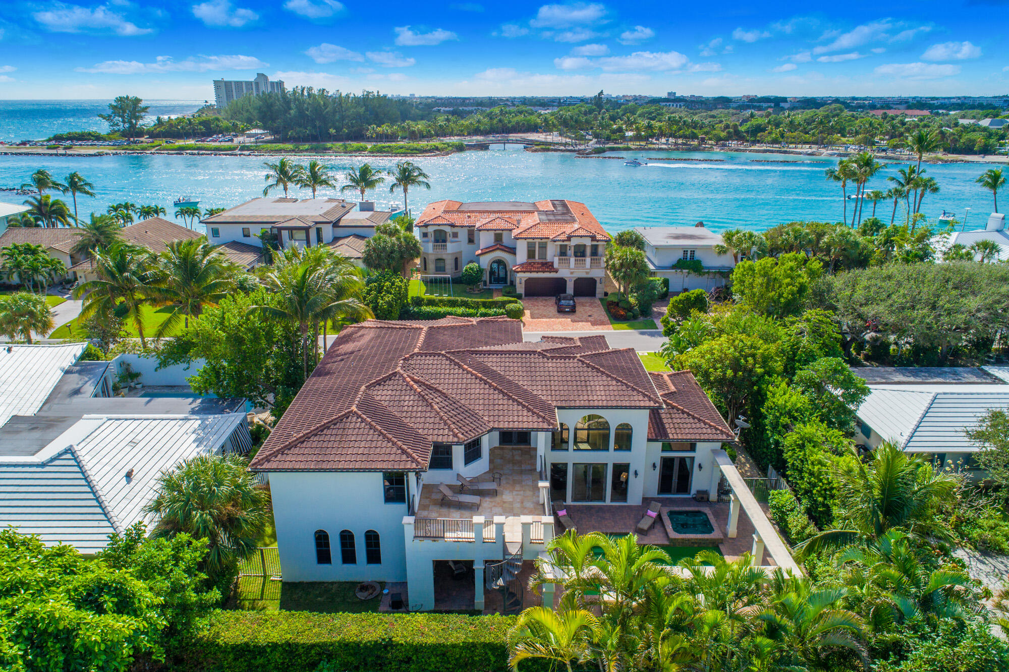 a aerial view of a house with outdoor seating and lake view