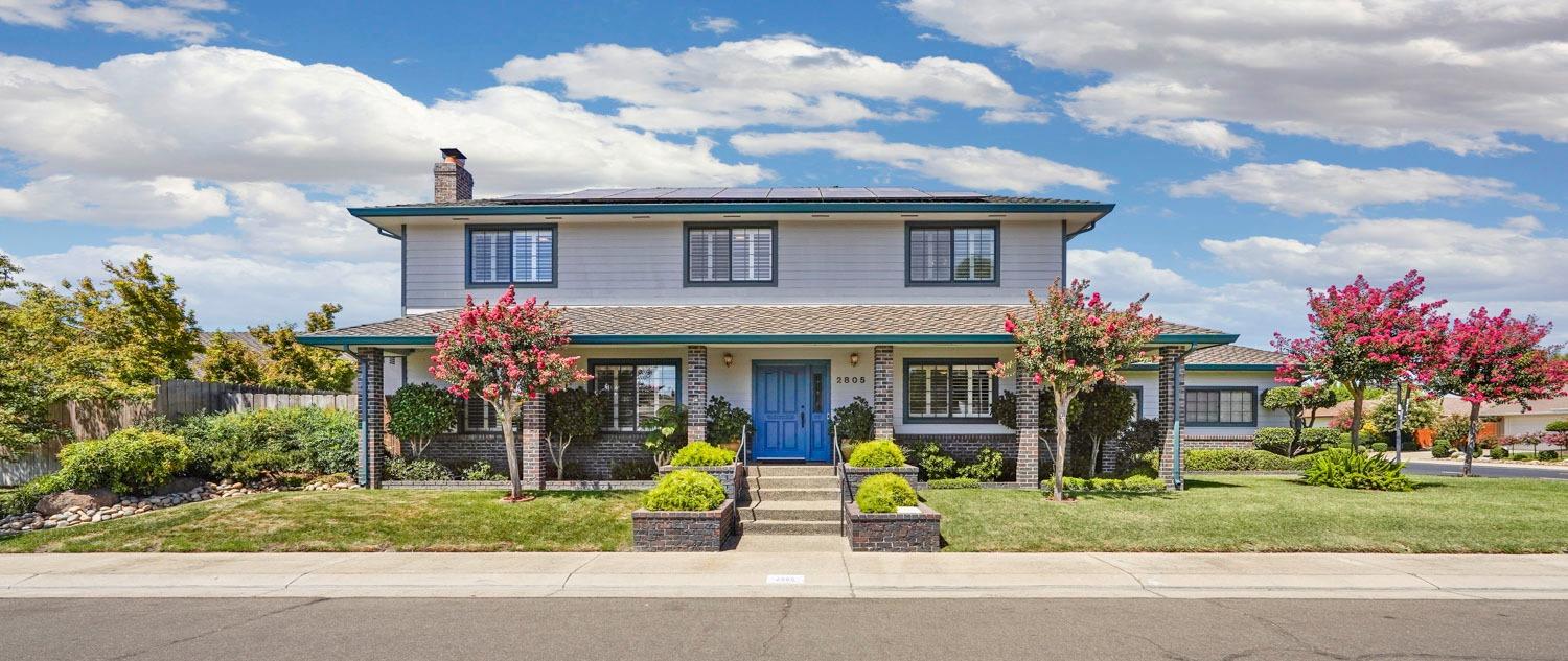 a front view of house with a garden