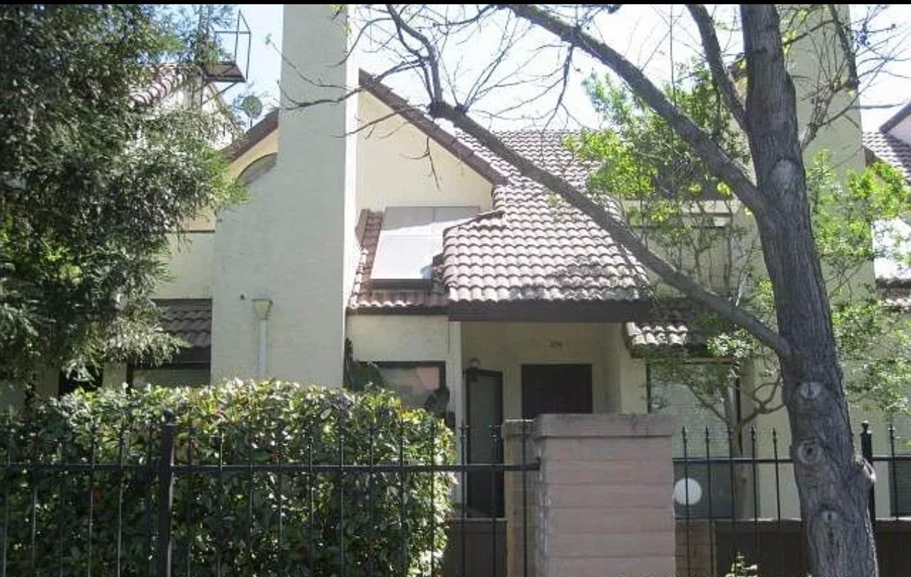 a view of a house with a tree next to a yard