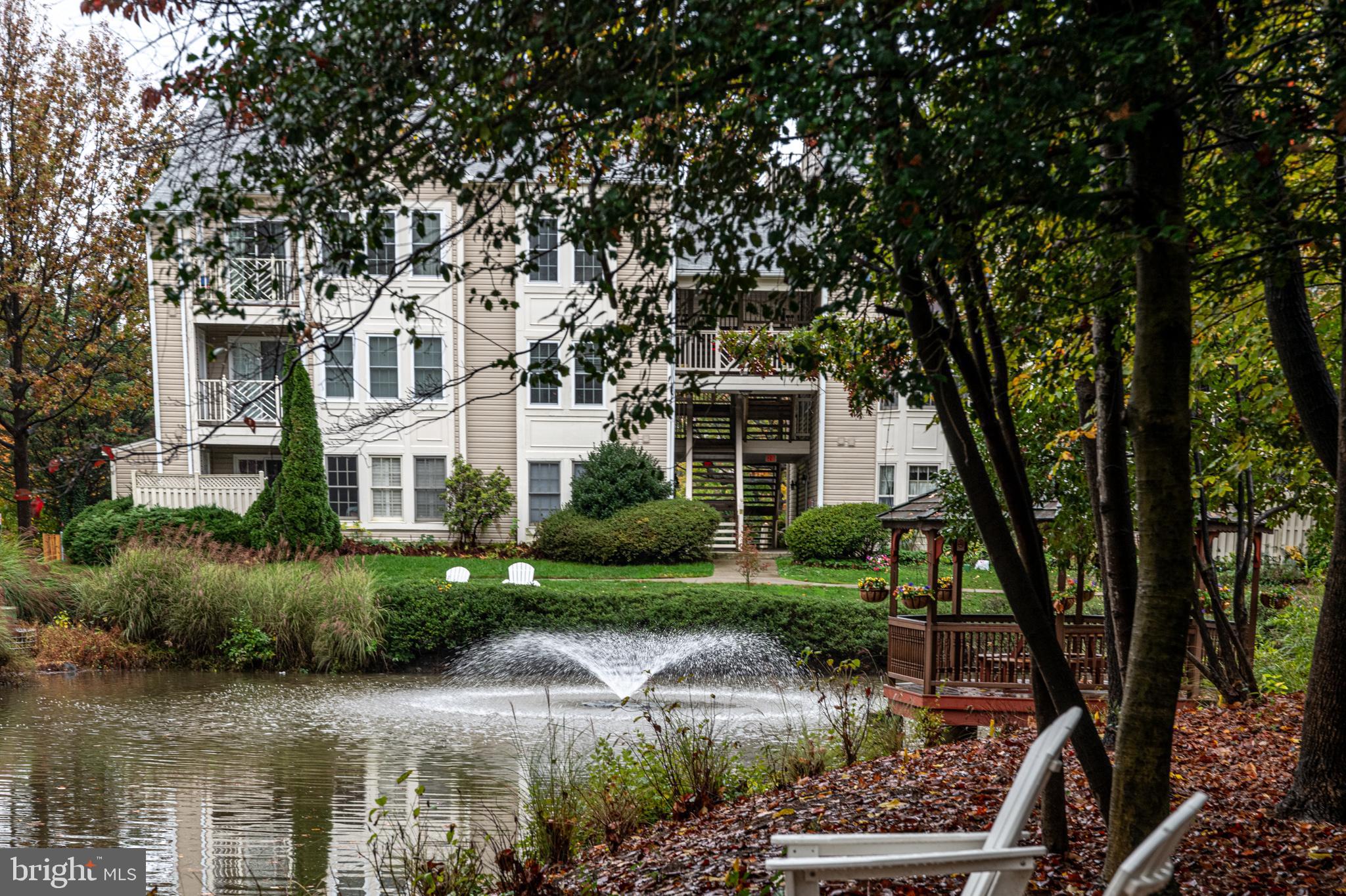 a front view of a house with a yard and lake view