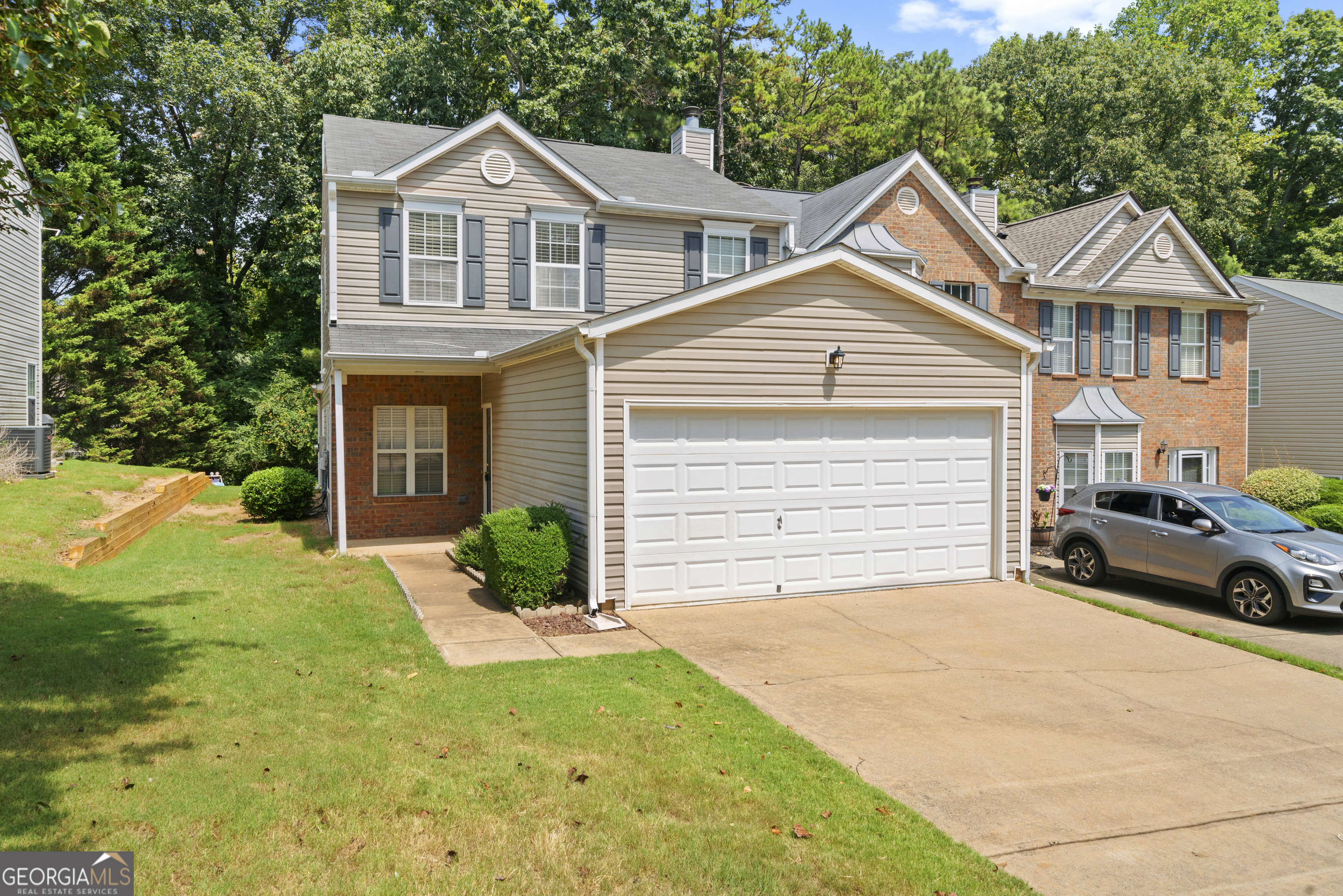 a view of a house with a yard and garage