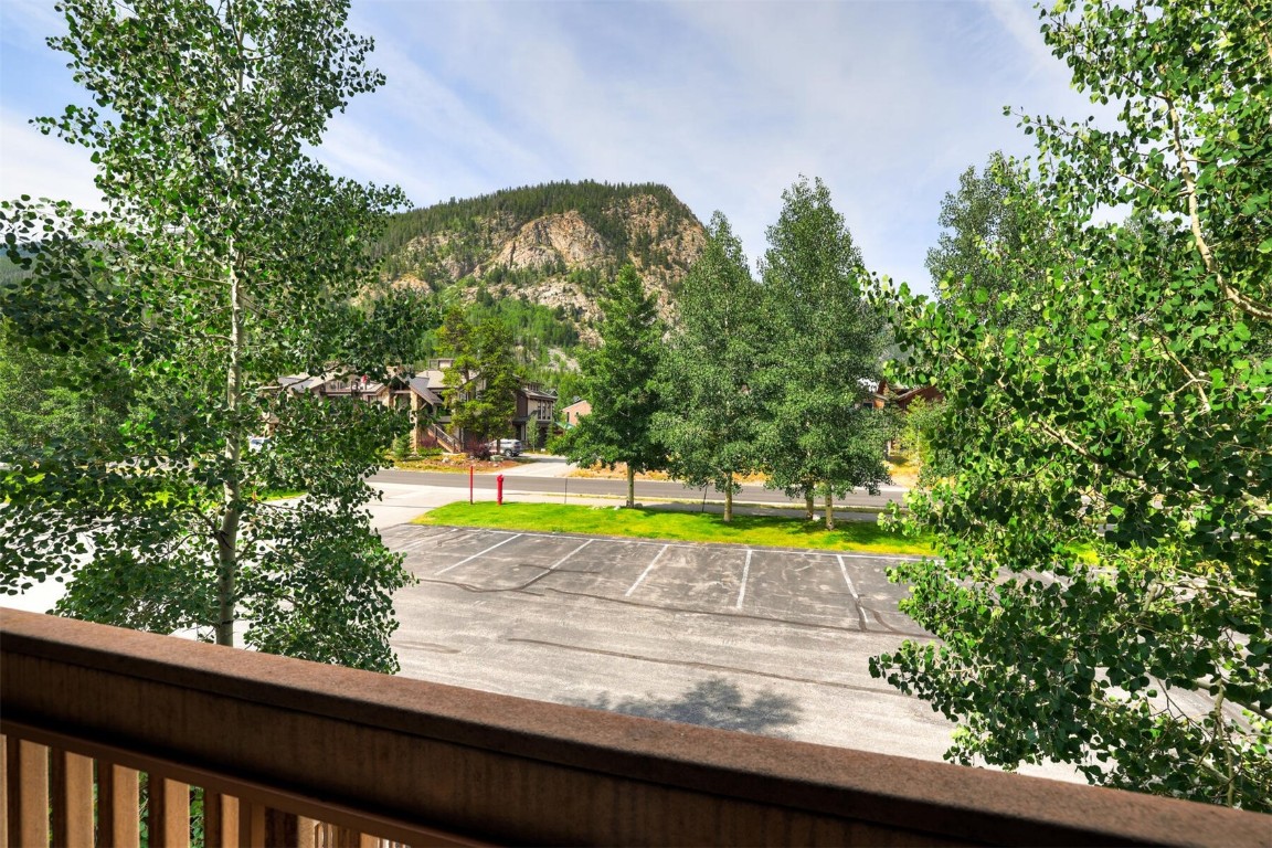 a view of a swimming pool with an outdoor seating and a forest