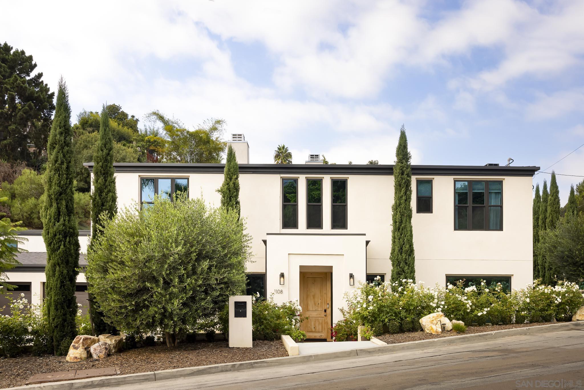 a front view of a house with a garden