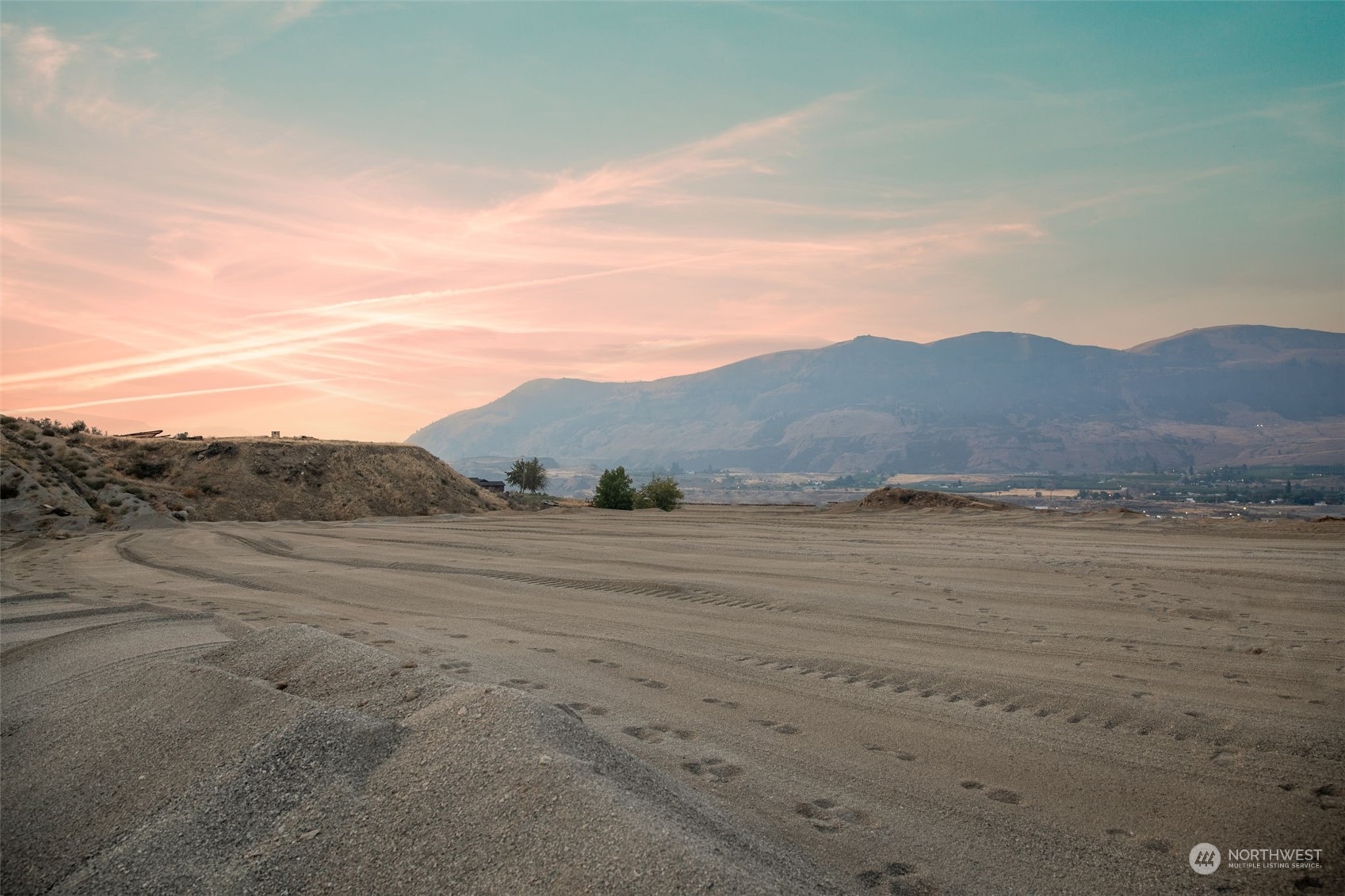 a view of an ocean beach and mountain