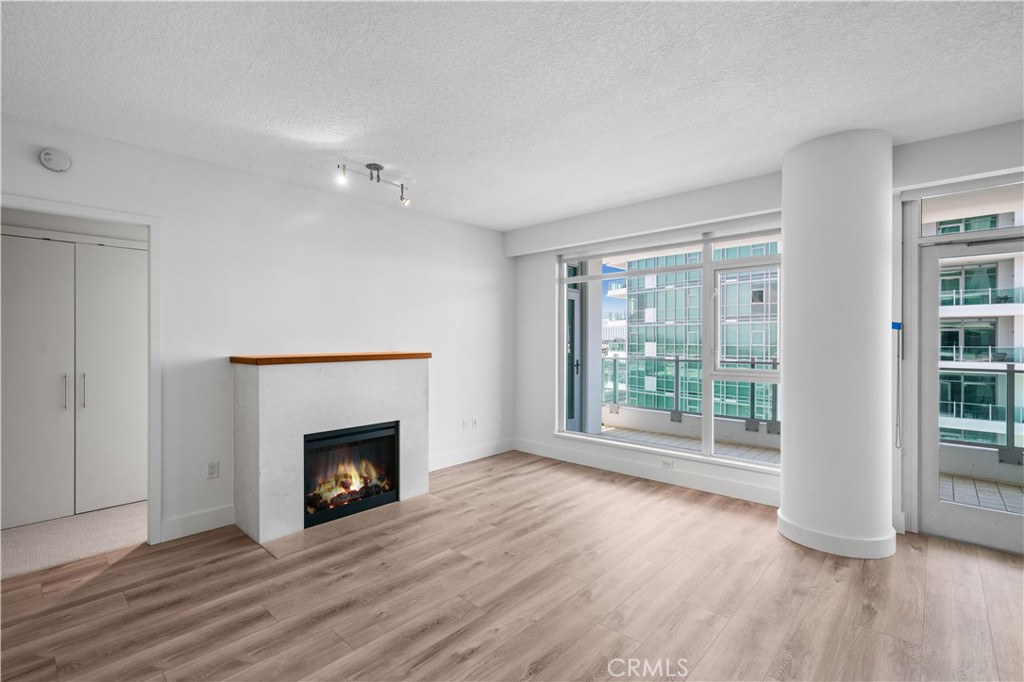 wooden floor fireplace and natural light in room