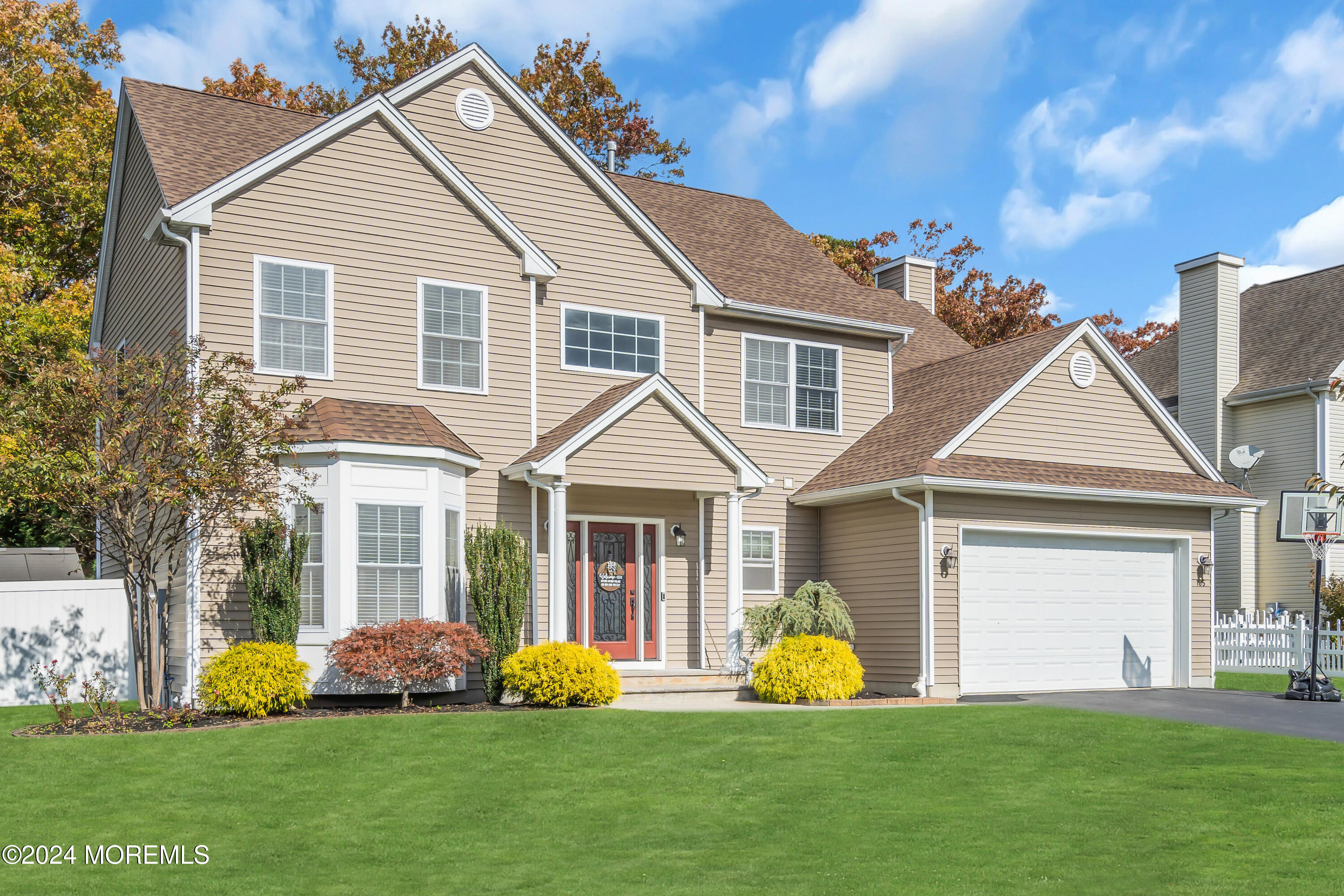 a front view of a house with garden and porch